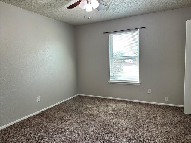 spare room with carpet flooring, ceiling fan, a textured ceiling, and baseboards