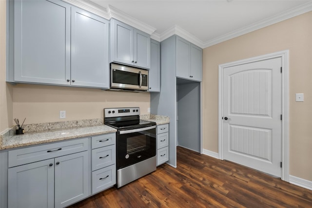 kitchen featuring gray cabinetry, dark hardwood / wood-style flooring, light stone counters, stainless steel appliances, and crown molding