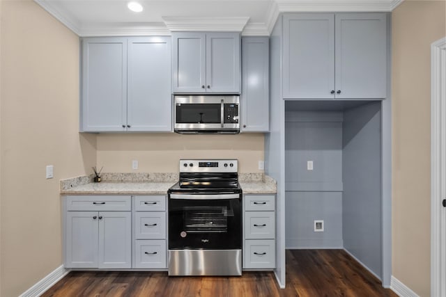 kitchen with light stone countertops, dark hardwood / wood-style floors, and appliances with stainless steel finishes