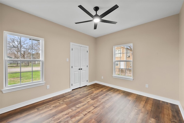 interior space featuring ceiling fan, dark hardwood / wood-style floors, and a closet