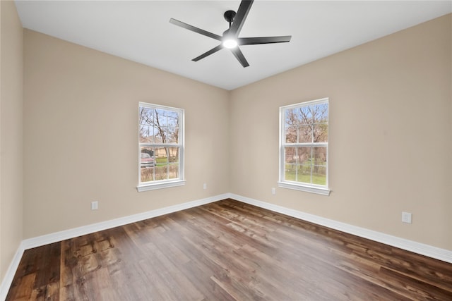 empty room with hardwood / wood-style floors and ceiling fan