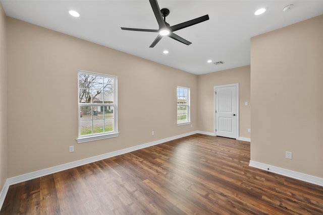 empty room featuring ceiling fan and dark hardwood / wood-style flooring