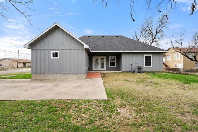 rear view of property featuring cooling unit, a patio area, and a lawn