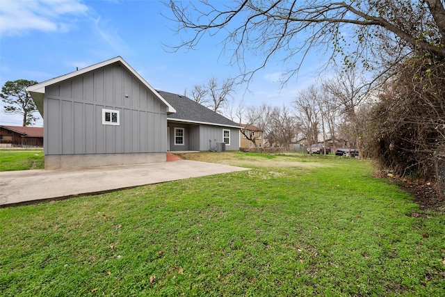 rear view of property with a patio and a lawn