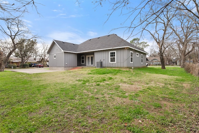 rear view of property featuring cooling unit, a yard, and a patio