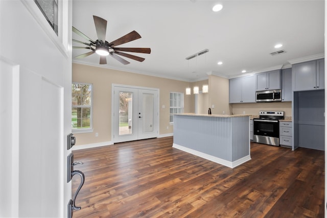 kitchen featuring gray cabinetry, crown molding, a center island, hanging light fixtures, and stainless steel appliances