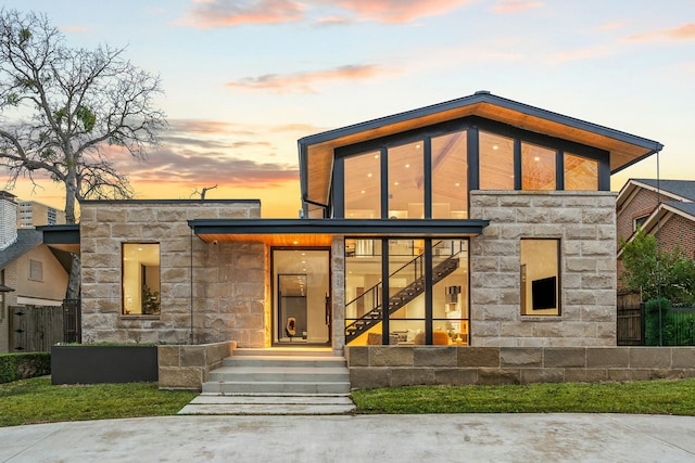 view of back house at dusk