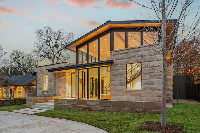 view of back house at dusk