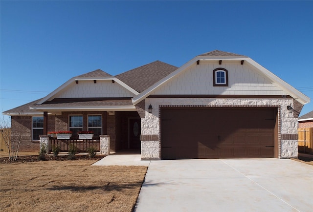 view of front of house featuring a porch and a garage