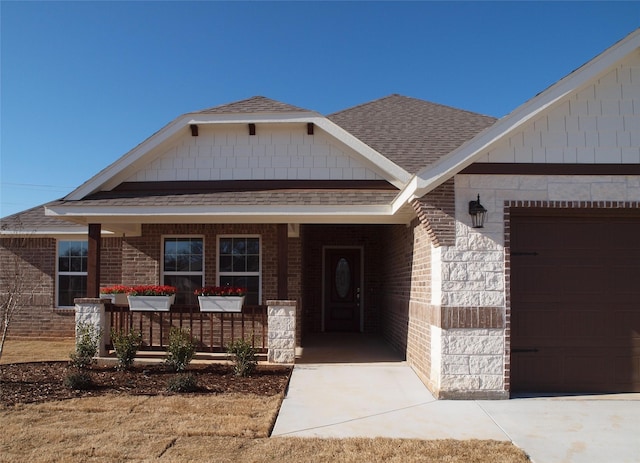 view of front of property featuring a garage and a porch