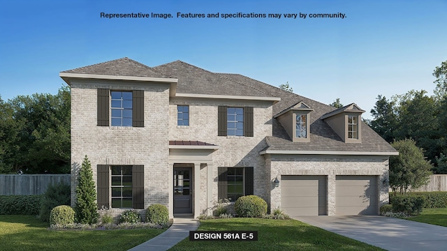 view of front of property featuring a garage and a front yard