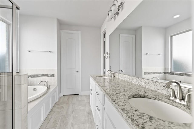 bathroom featuring vanity and a tub