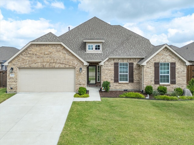 view of front facade with a garage and a front lawn