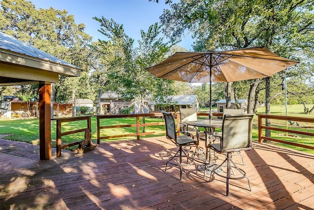 deck with a shed and a yard