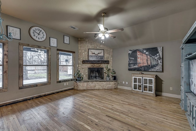 unfurnished living room featuring light hardwood / wood-style flooring, a fireplace, ceiling fan, and vaulted ceiling