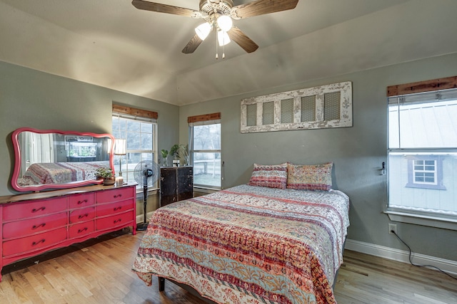 bedroom with vaulted ceiling, ceiling fan, and light wood-type flooring