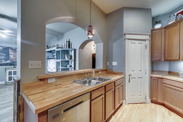 kitchen with sink, light hardwood / wood-style floors, wood counters, decorative light fixtures, and stainless steel dishwasher