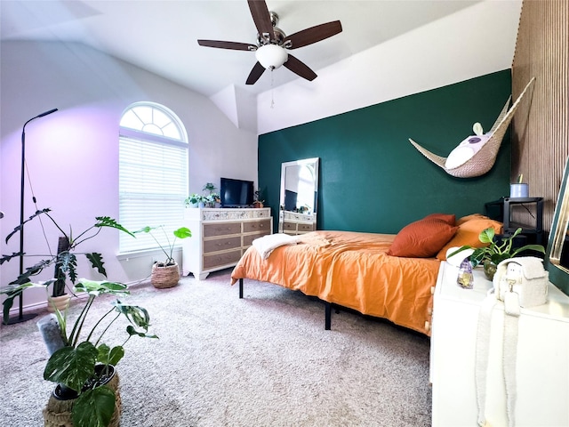 bedroom featuring lofted ceiling, ceiling fan, and carpet