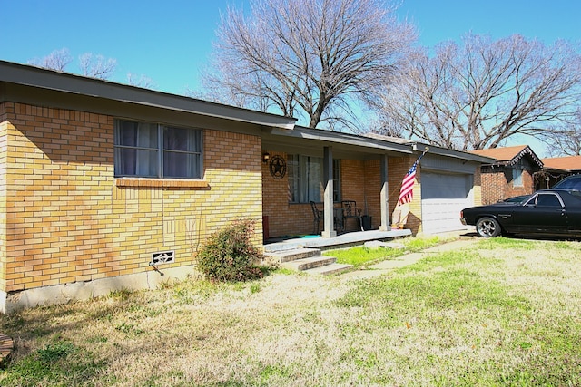 single story home featuring a garage and a front lawn