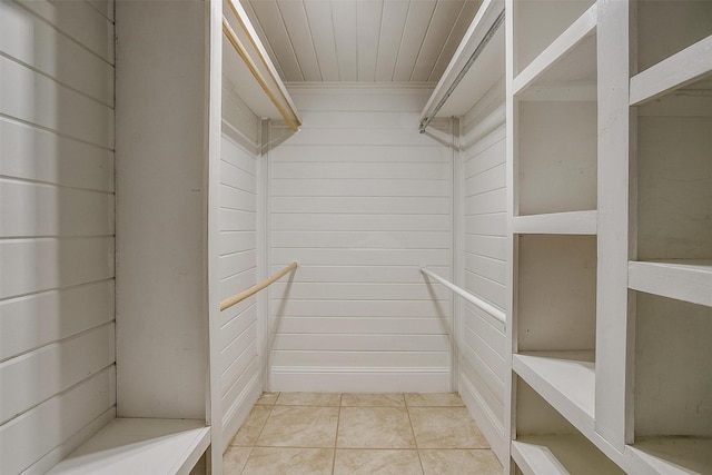 walk in closet with light tile patterned floors