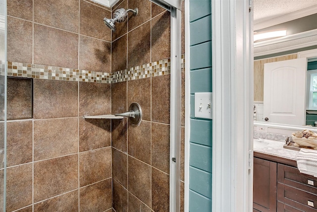 details with vanity, tiled shower, and ornamental molding