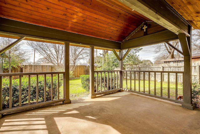 unfurnished sunroom featuring vaulted ceiling