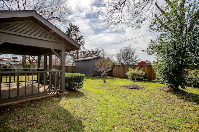 view of yard featuring a storage unit and a deck