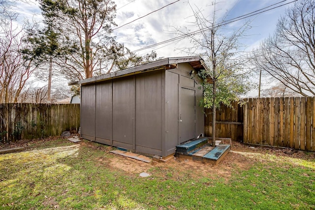 view of outbuilding with a yard