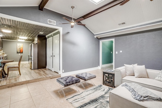 tiled living room featuring ceiling fan and vaulted ceiling with beams