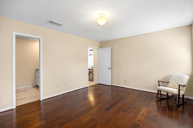 interior space featuring hardwood / wood-style flooring and a textured ceiling