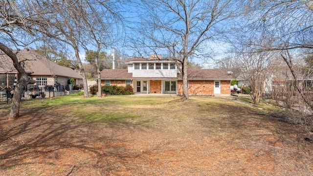 view of front of home featuring a front lawn and a sunroom