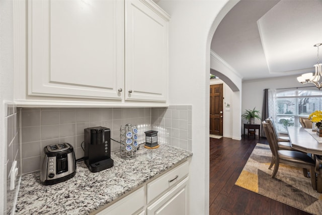 kitchen with white cabinetry, dark hardwood / wood-style flooring, and a chandelier