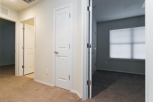 hall featuring light colored carpet