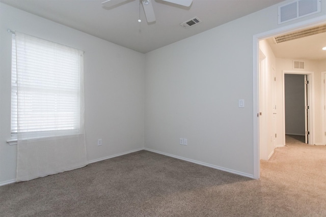 empty room with light colored carpet and ceiling fan