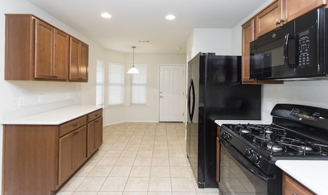 kitchen featuring hanging light fixtures, light tile patterned floors, and black appliances