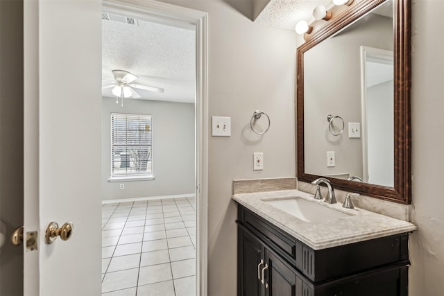 bathroom featuring tile patterned flooring, vanity, a textured ceiling, and ceiling fan