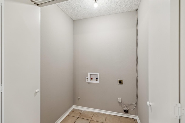 laundry area with washer hookup, electric dryer hookup, a textured ceiling, and light tile patterned floors