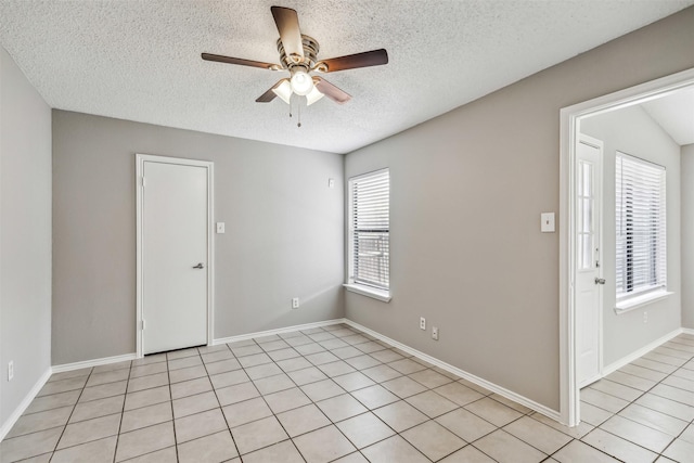 empty room featuring a textured ceiling and ceiling fan