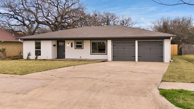 ranch-style house with a garage and a front yard