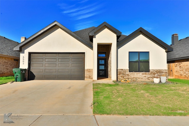 view of front of house with a garage and a front lawn