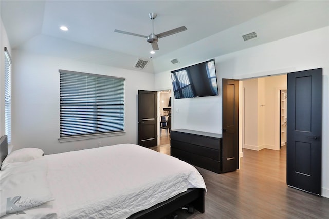 bedroom with vaulted ceiling, dark wood-type flooring, and ceiling fan