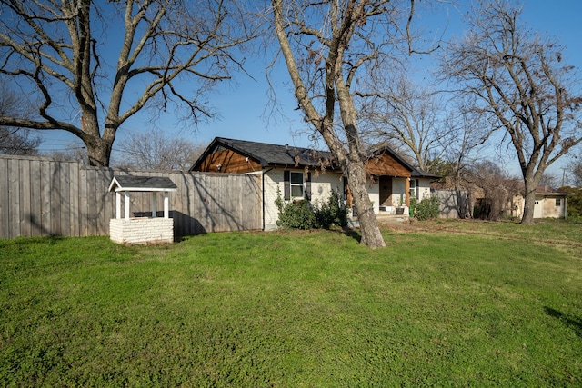 rear view of property with a lawn