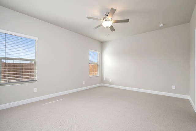 empty room featuring ceiling fan and carpet floors