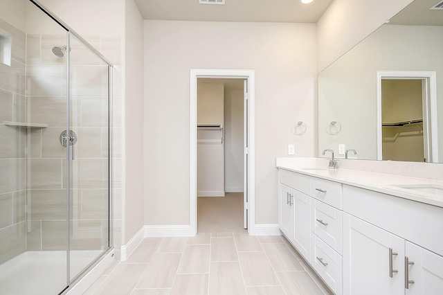 bathroom featuring walk in shower and vanity