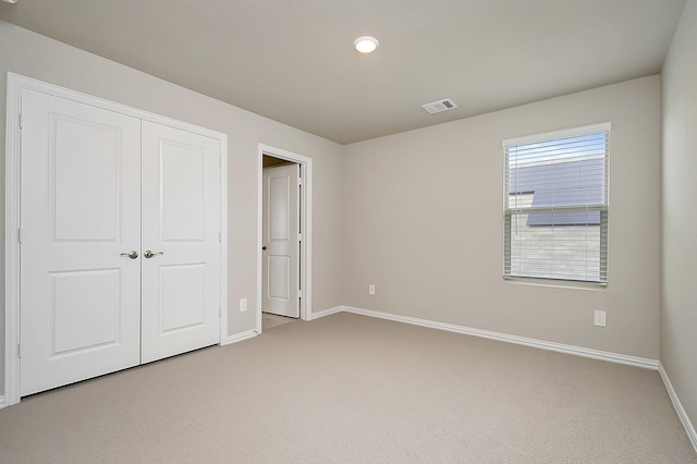 unfurnished bedroom with carpet flooring and a closet