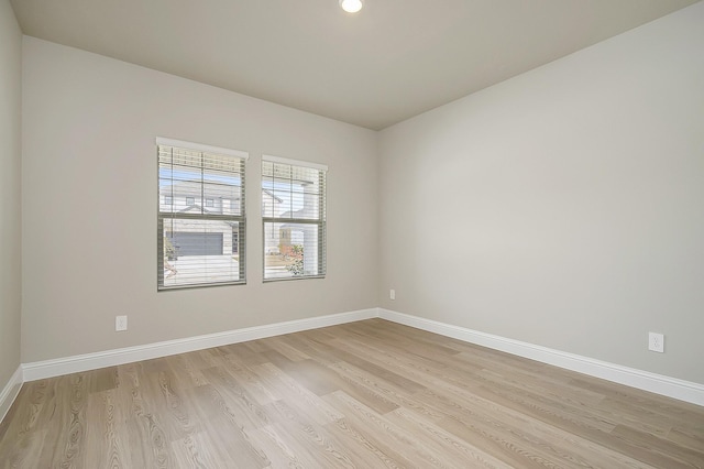 spare room featuring light wood-type flooring