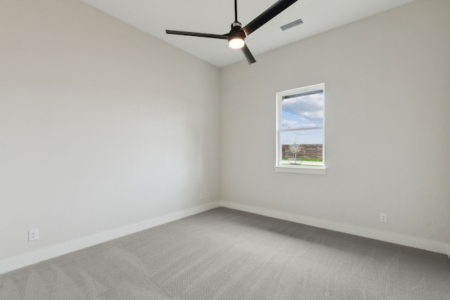 empty room with ceiling fan and carpet