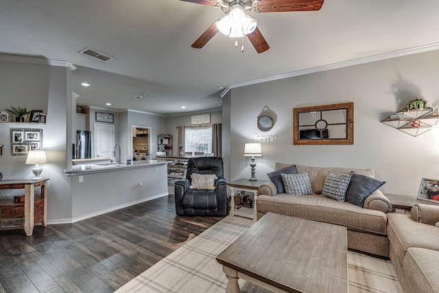 living room with dark hardwood / wood-style flooring, ornamental molding, sink, and ceiling fan