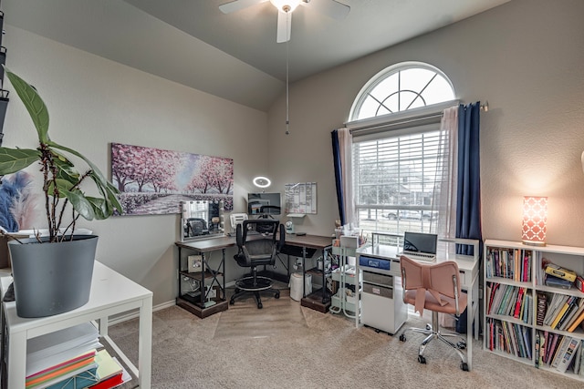 home office featuring vaulted ceiling, ceiling fan, and light colored carpet