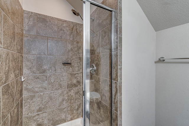 bathroom featuring vaulted ceiling and walk in shower